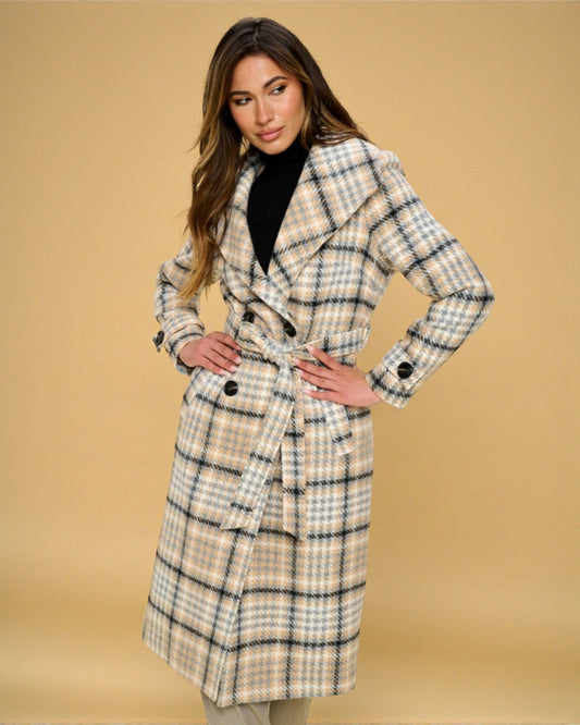 Woman wearing a plaid coat against a beige background