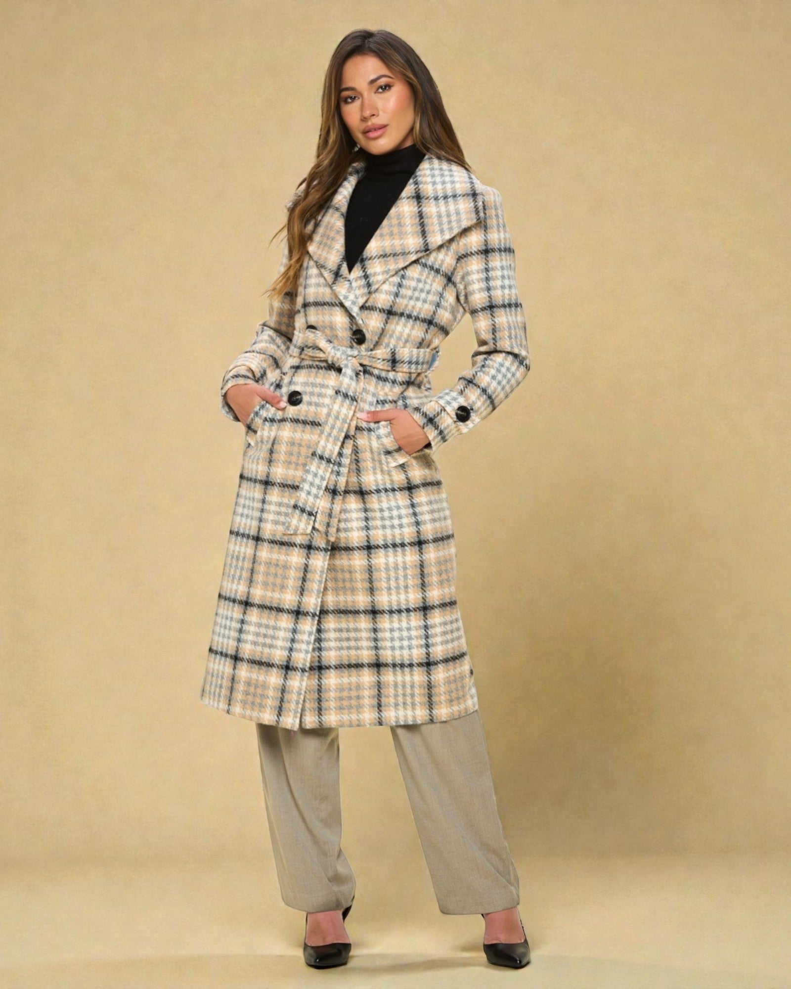 Woman wearing a plaid coat on a beige background