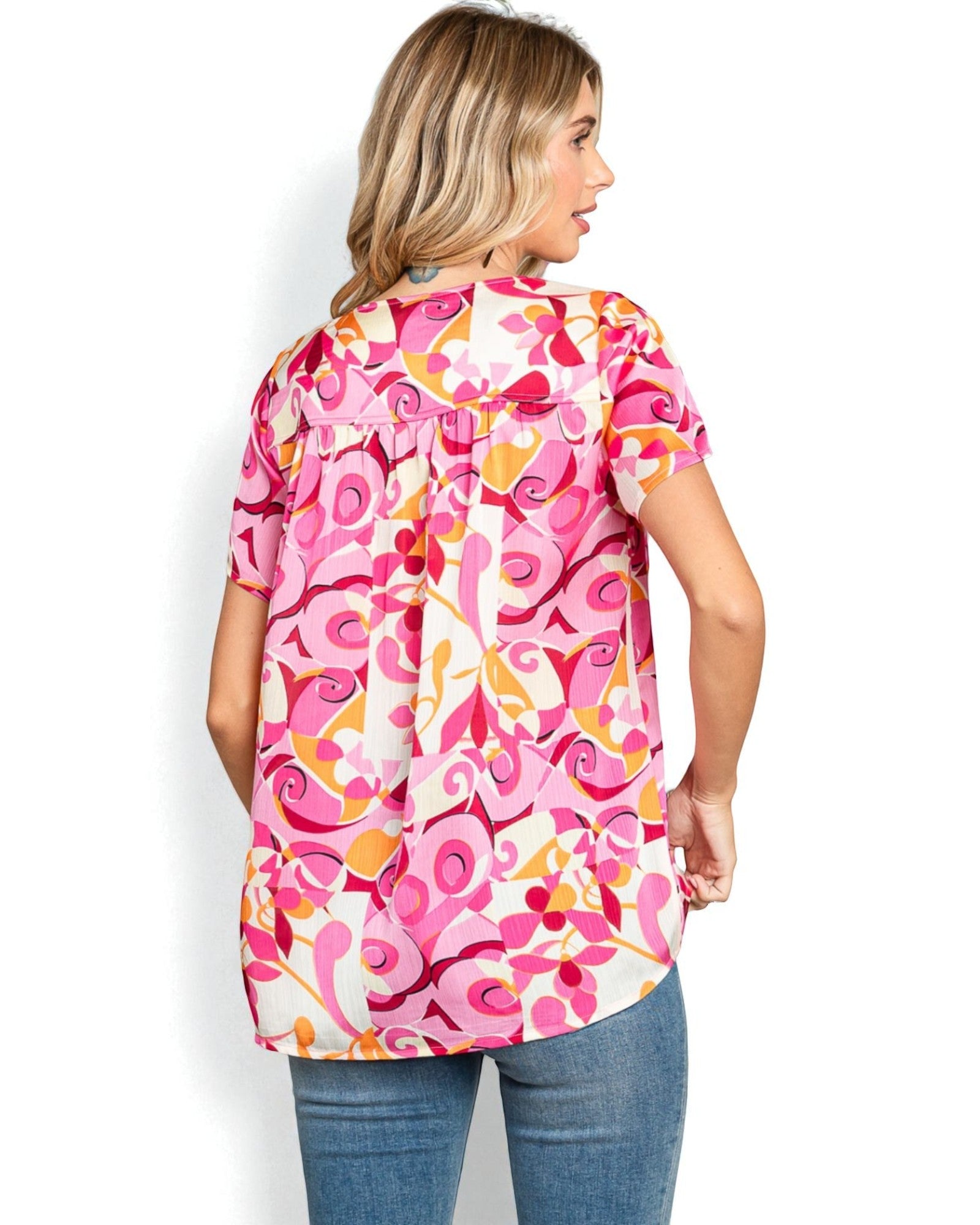 Woman wearing a colorful patterned shirt on a white background