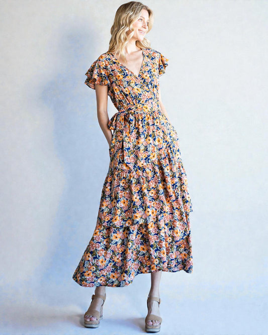 Woman wearing a floral dress against a plain background