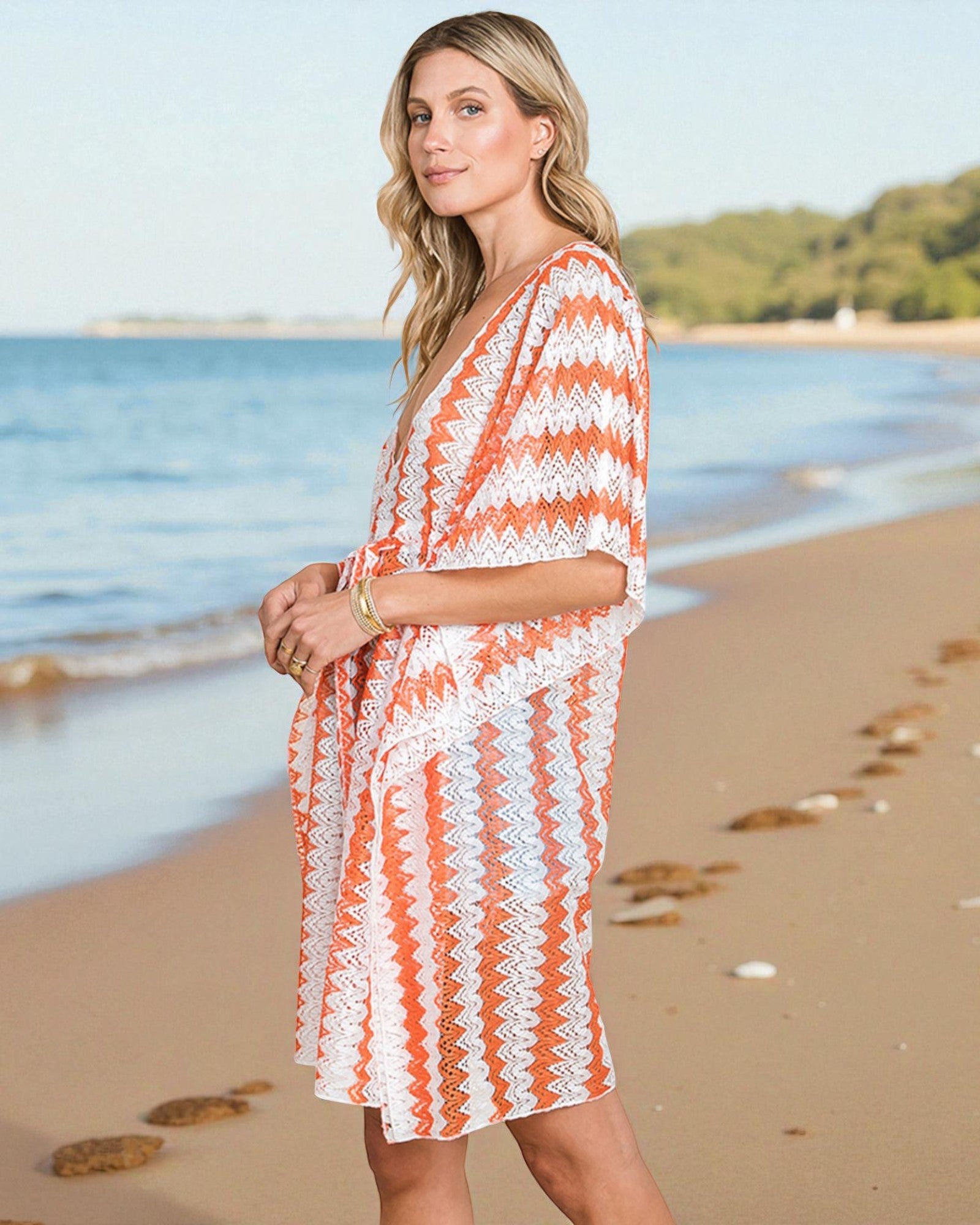 Woman in a striped orange and white cover-up on a beach