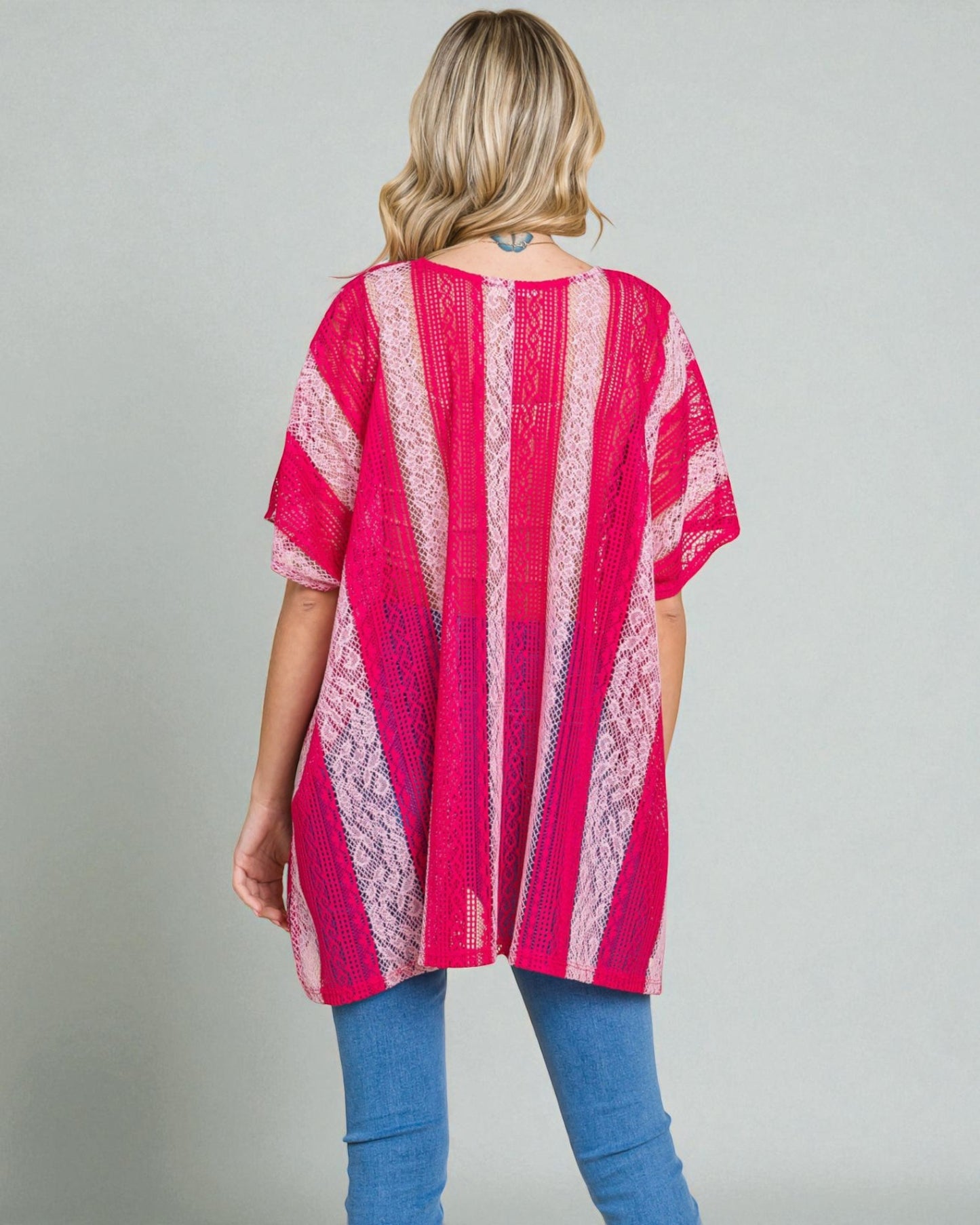 Woman wearing a pink and white striped kimono against a gray background