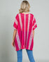 Woman wearing a pink and white striped kimono against a gray background