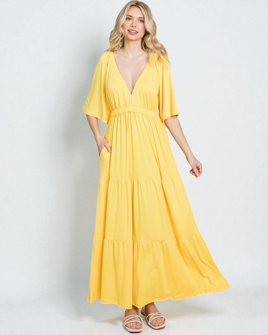 Woman wearing a yellow dress on a white background