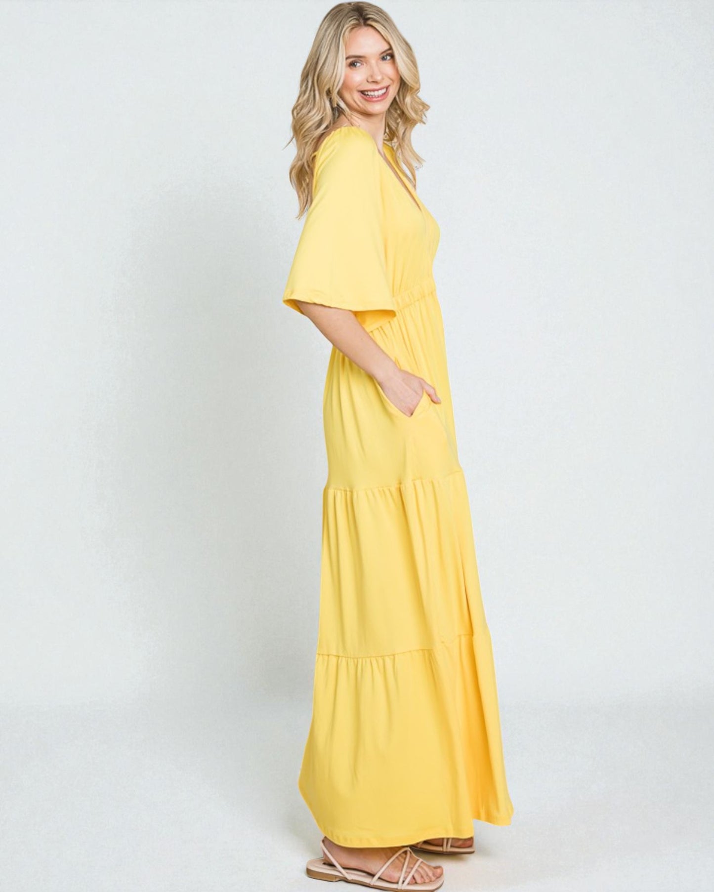 Woman wearing a yellow dress on a white background