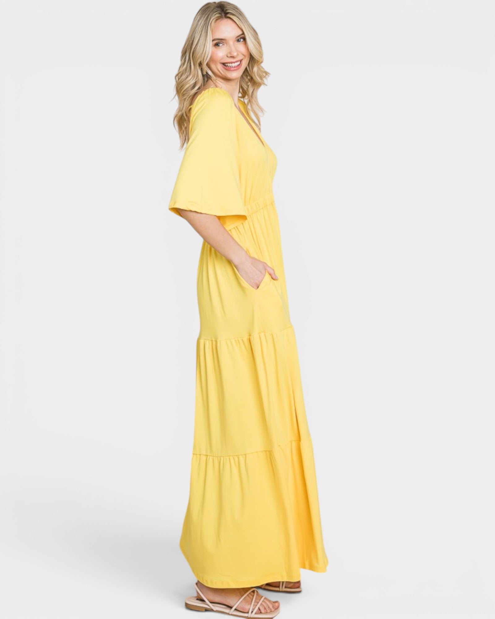 Woman wearing a yellow dress on a white background