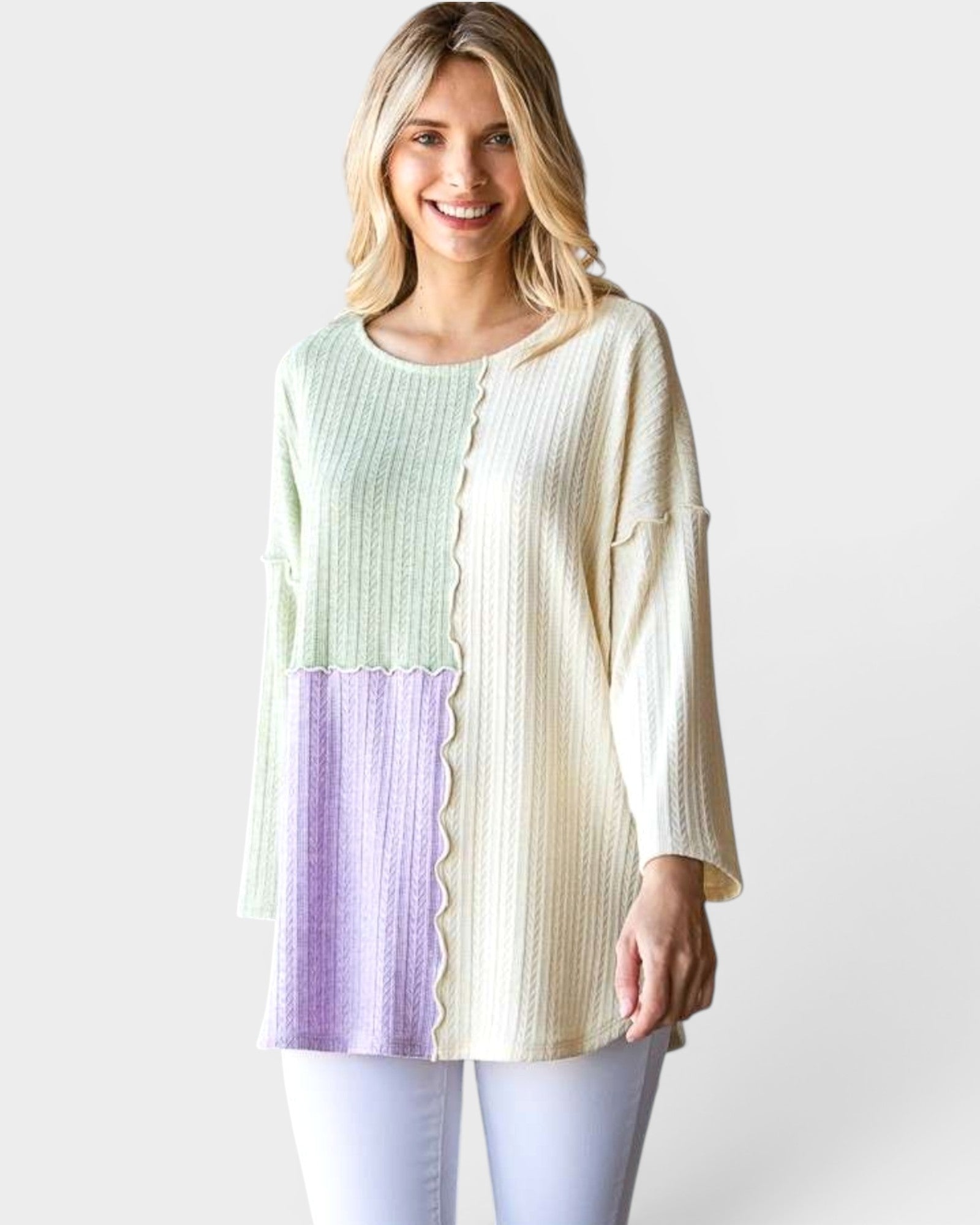 Woman wearing a colorful top with a white background