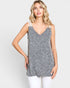 Woman wearing a gray sleeveless top with white trim on a light gray background