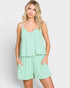 A woman modeling a light green and white striped romper with side pockets, set against a plain light gray background.