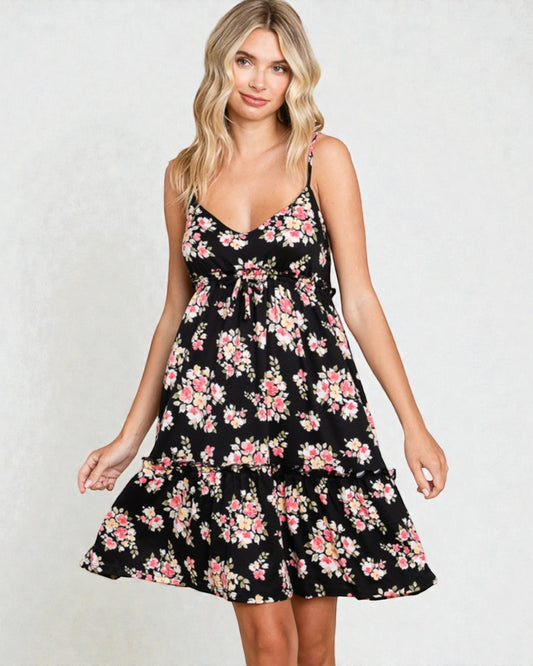 Woman wearing a black floral dress on a white background