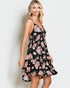 Woman wearing a black floral dress against a white background