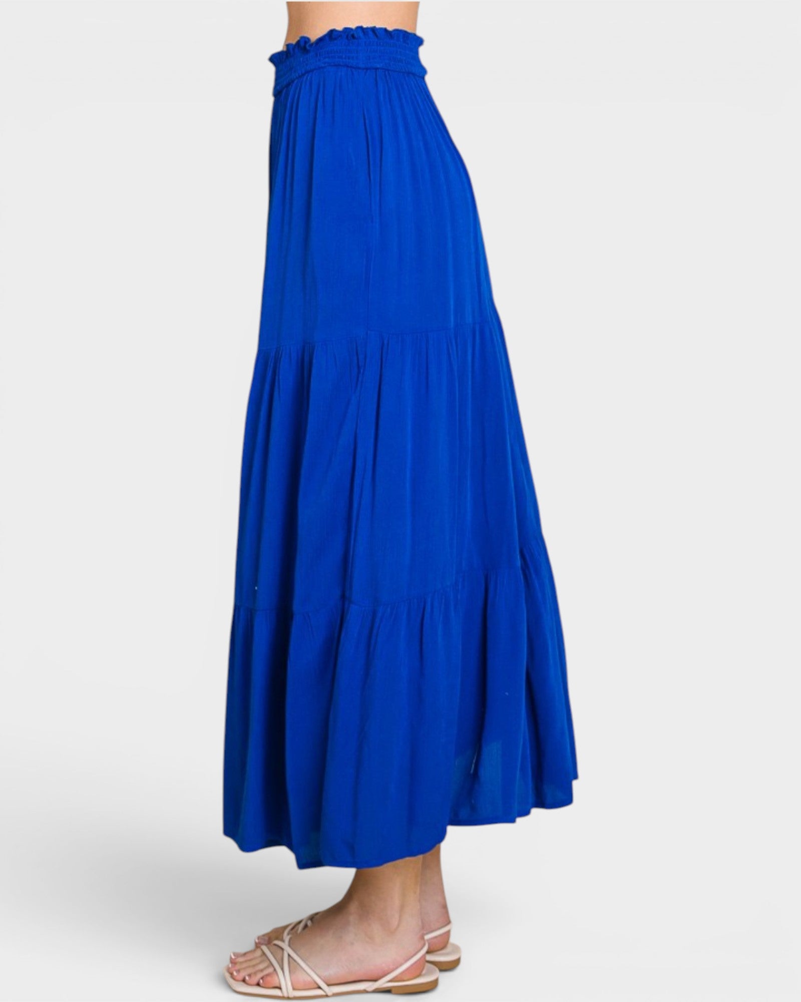 Blue skirt worn by a person on a white background
