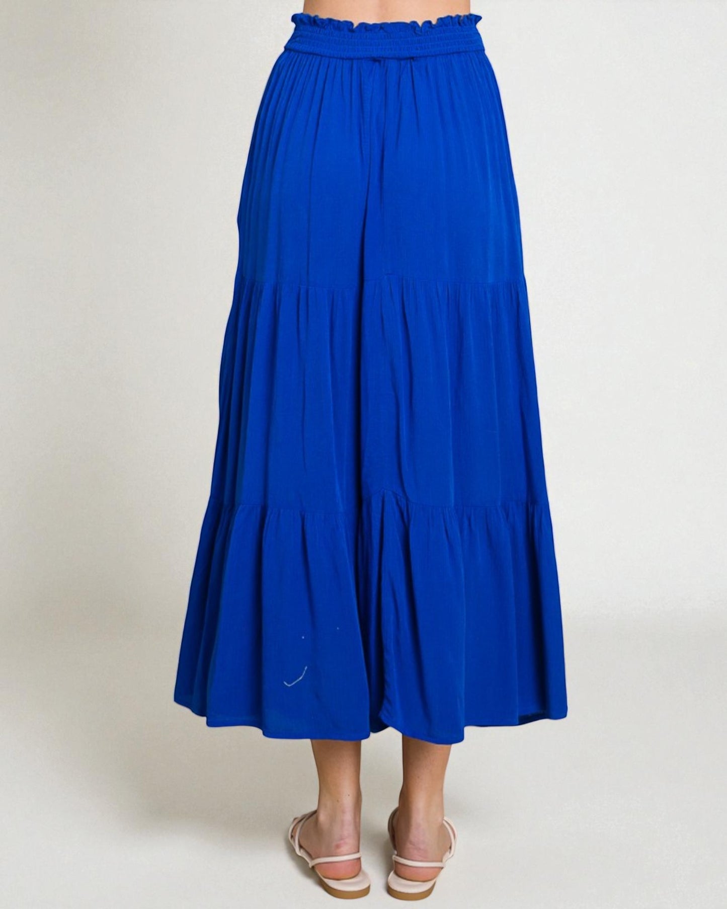 Blue tiered skirt on a plain background