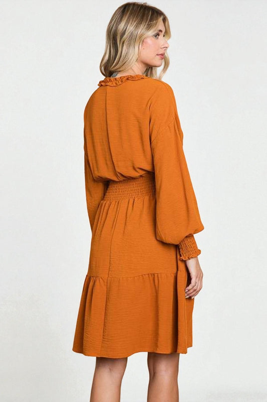 Woman wearing an orange dress on a white background