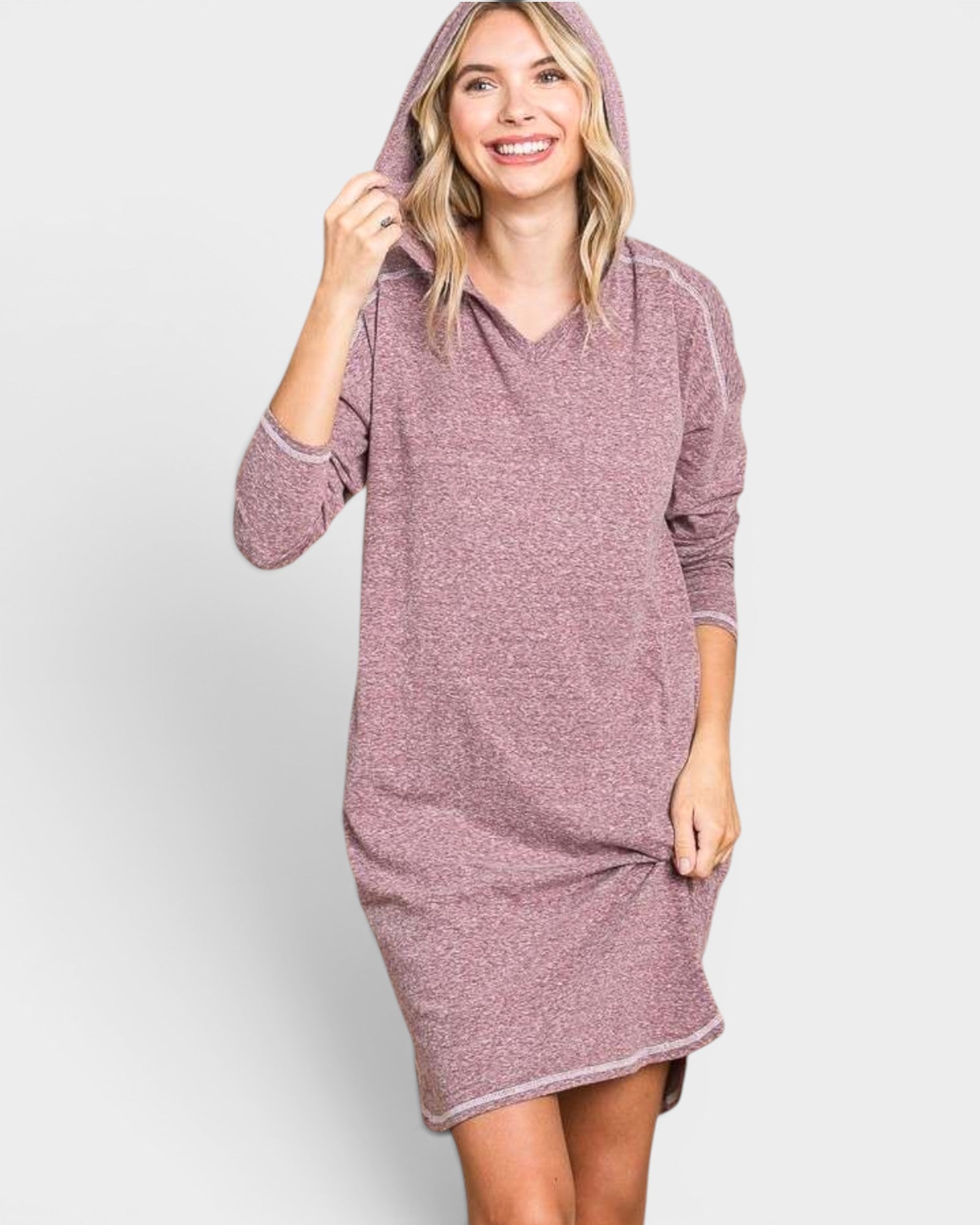Woman wearing a hooded dress against a white background
