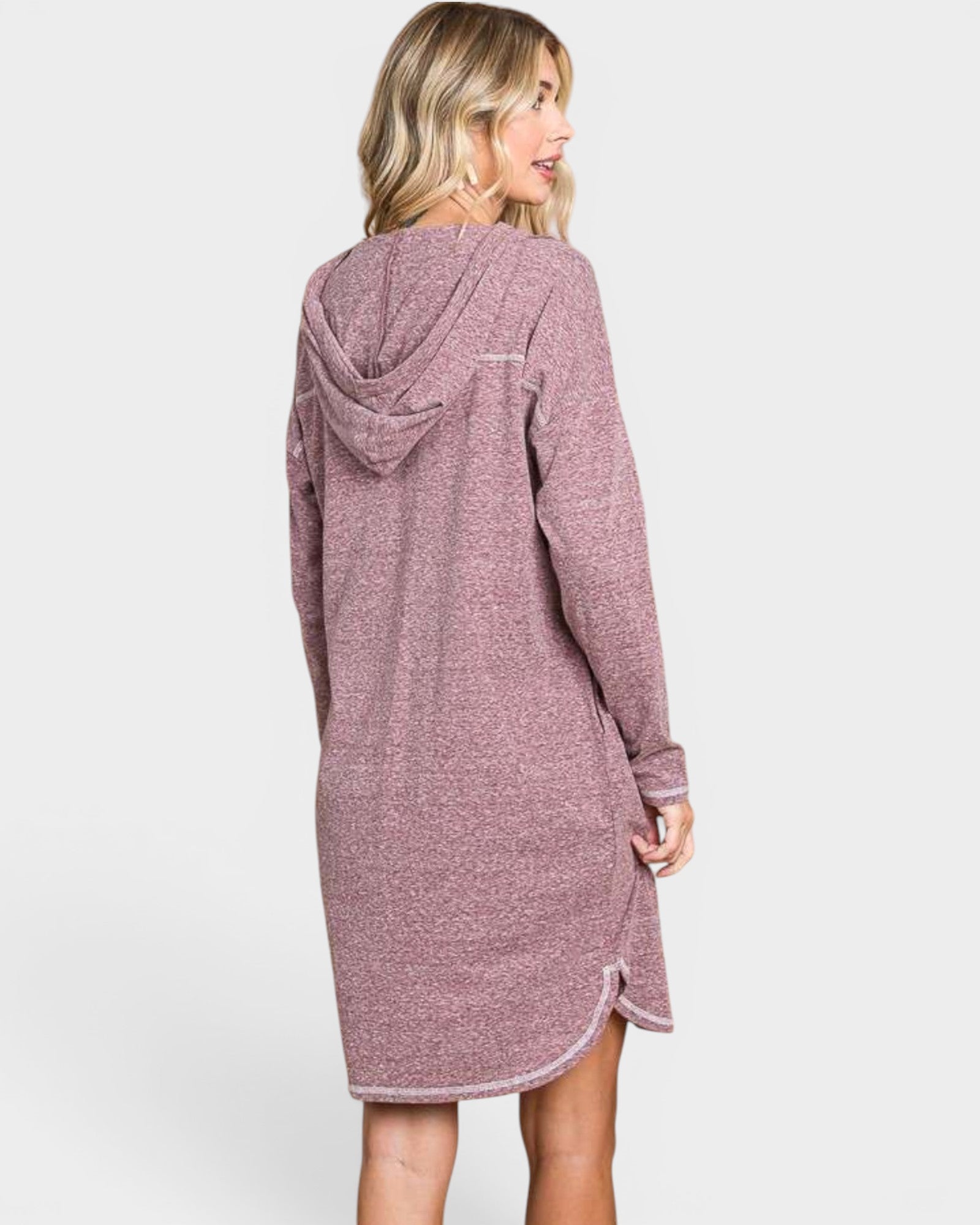 Woman wearing a pink hooded dress on a white background