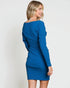 Woman wearing a blue dress against a white background
