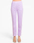 A model is wearing a pair of light purple cropped pants with a wide elastic waistband and side pleats, paired with beige flat sandals against a plain white background.