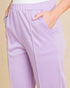 Lavender pants worn by a person on a beige background