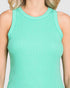 Person wearing a light green tank top against a neutral background