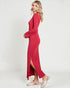 Woman wearing a red dress with a slit on a white background