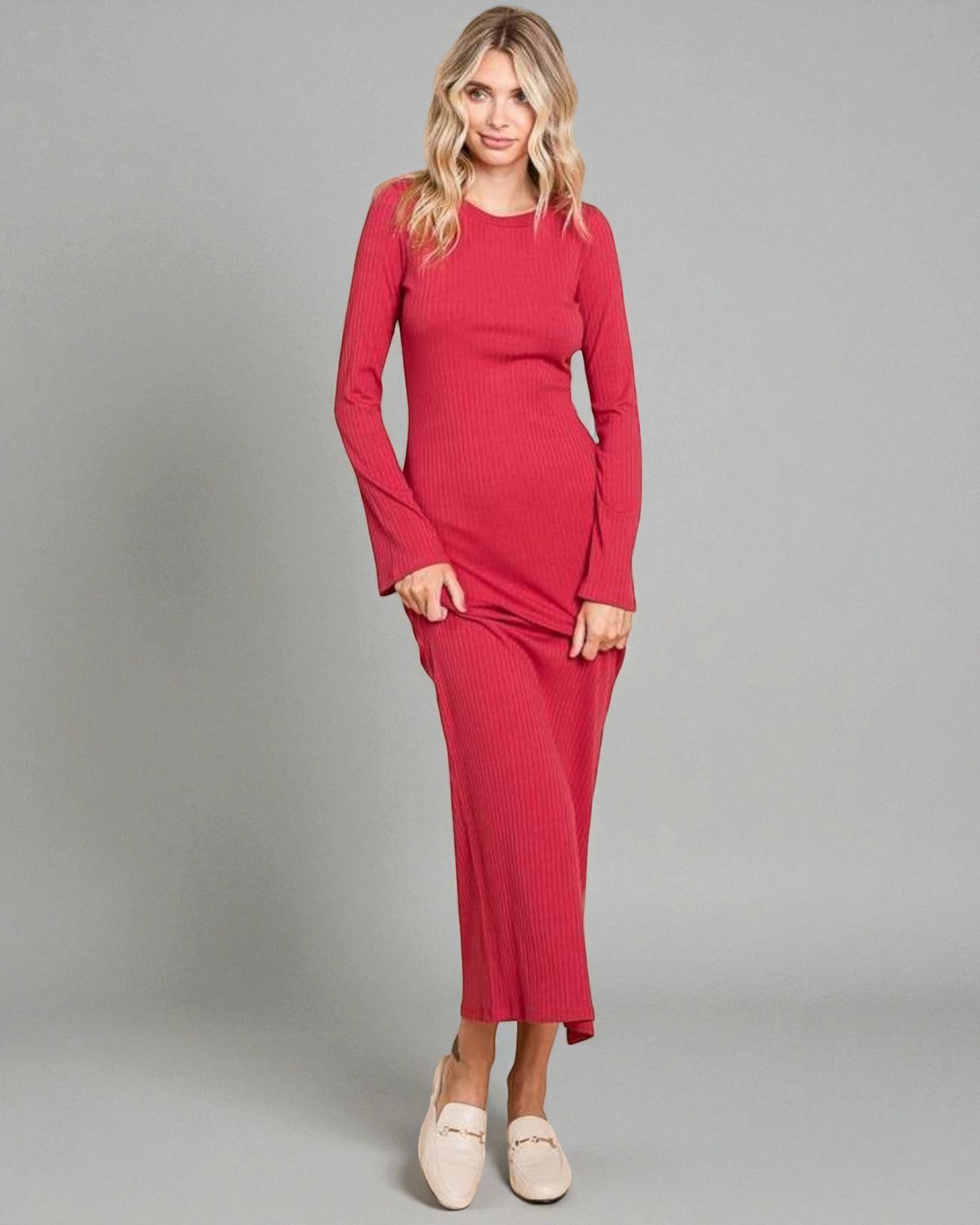 Woman wearing a red dress against a gray background