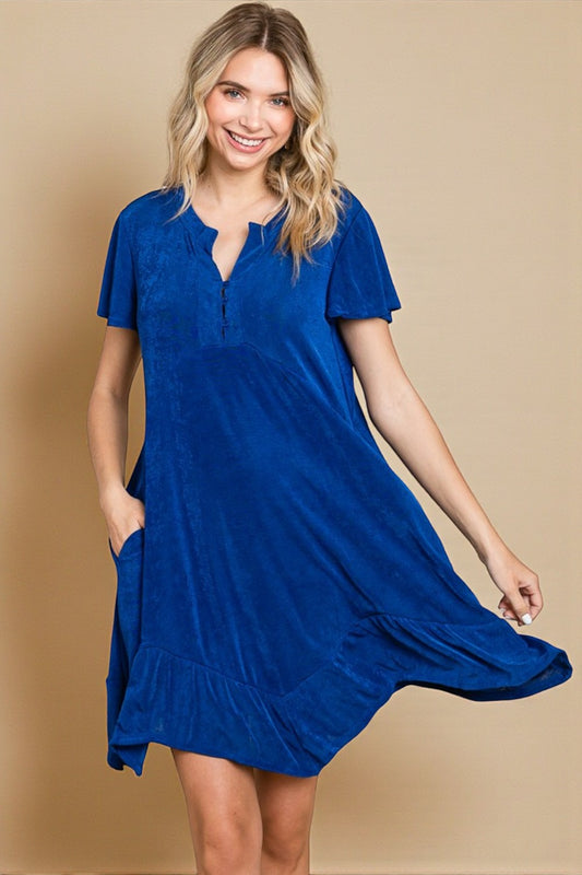 Woman wearing a blue dress on a beige background