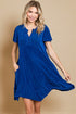 Woman wearing a blue dress on a beige background