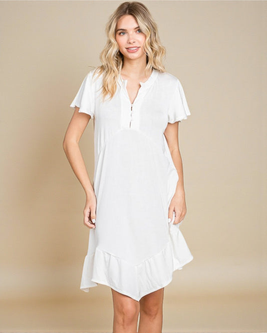 Woman wearing a white dress against a beige background