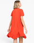 A woman wearing a bright orange short-sleeve shift dress, shown from the back against a plain white studio background.
