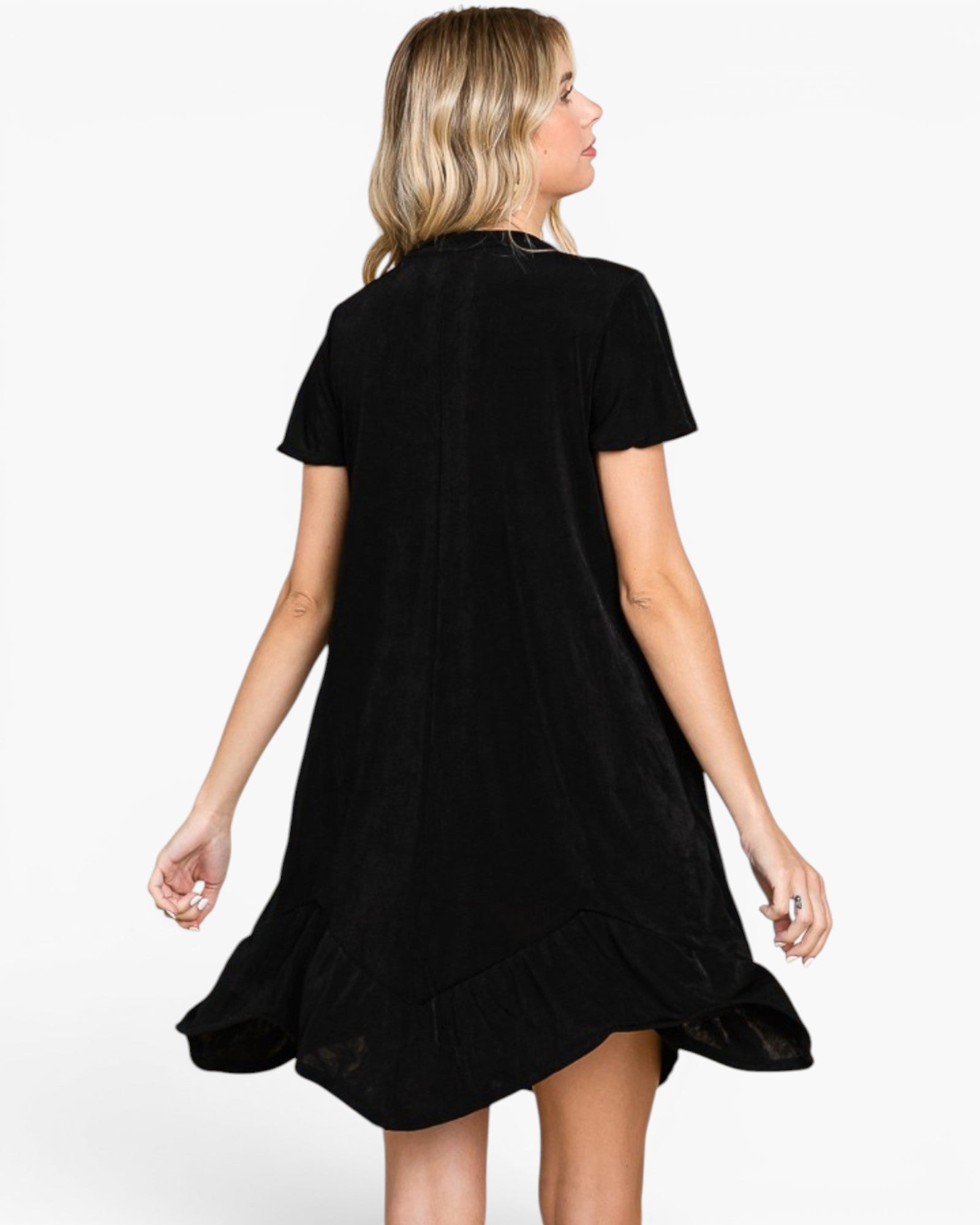 A woman wearing a black short-sleeve dress, shown from the back against a plain white studio background.