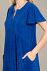 Blue dress worn by a person on a neutral background