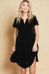 Woman wearing a black dress against a beige background