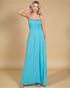 Woman wearing a turquoise maxi dress against a beige background