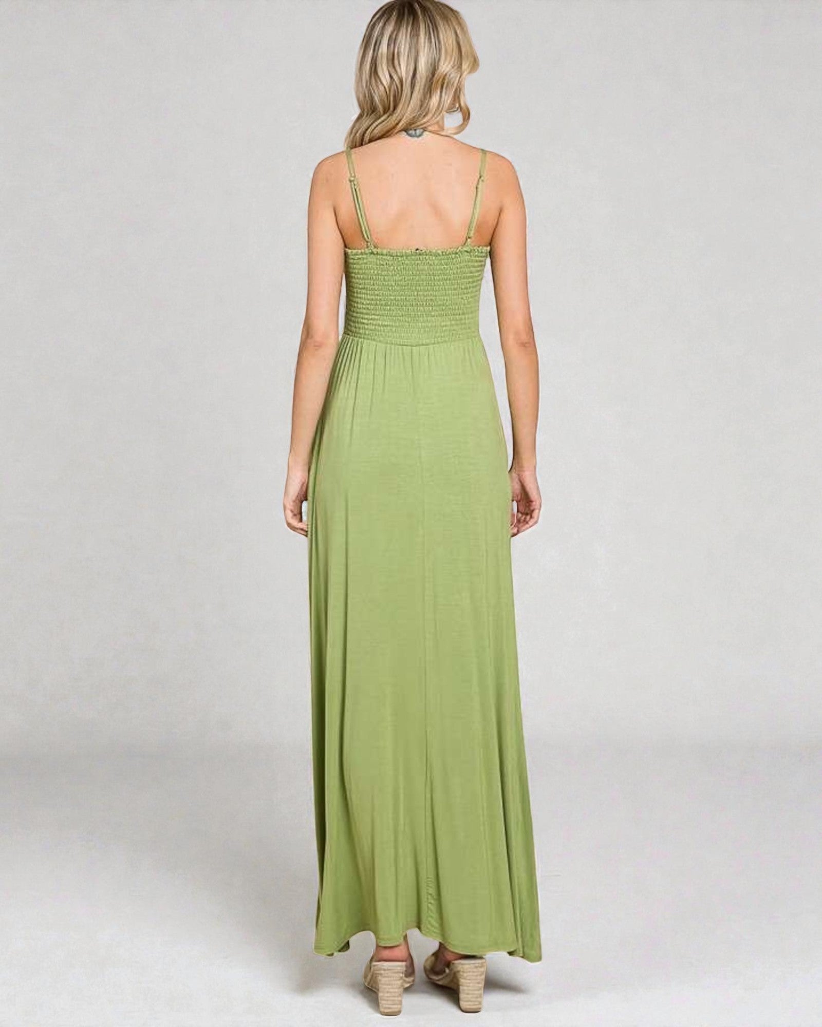 Green maxi dress worn by a person on a white background
