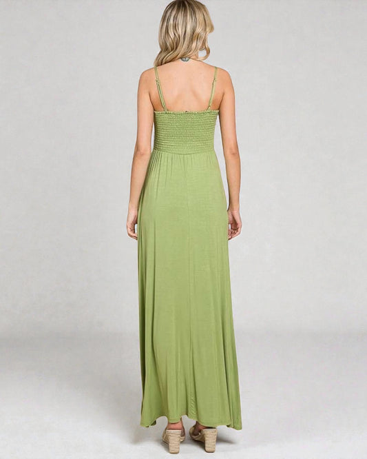 Green maxi dress worn by a person on a white background