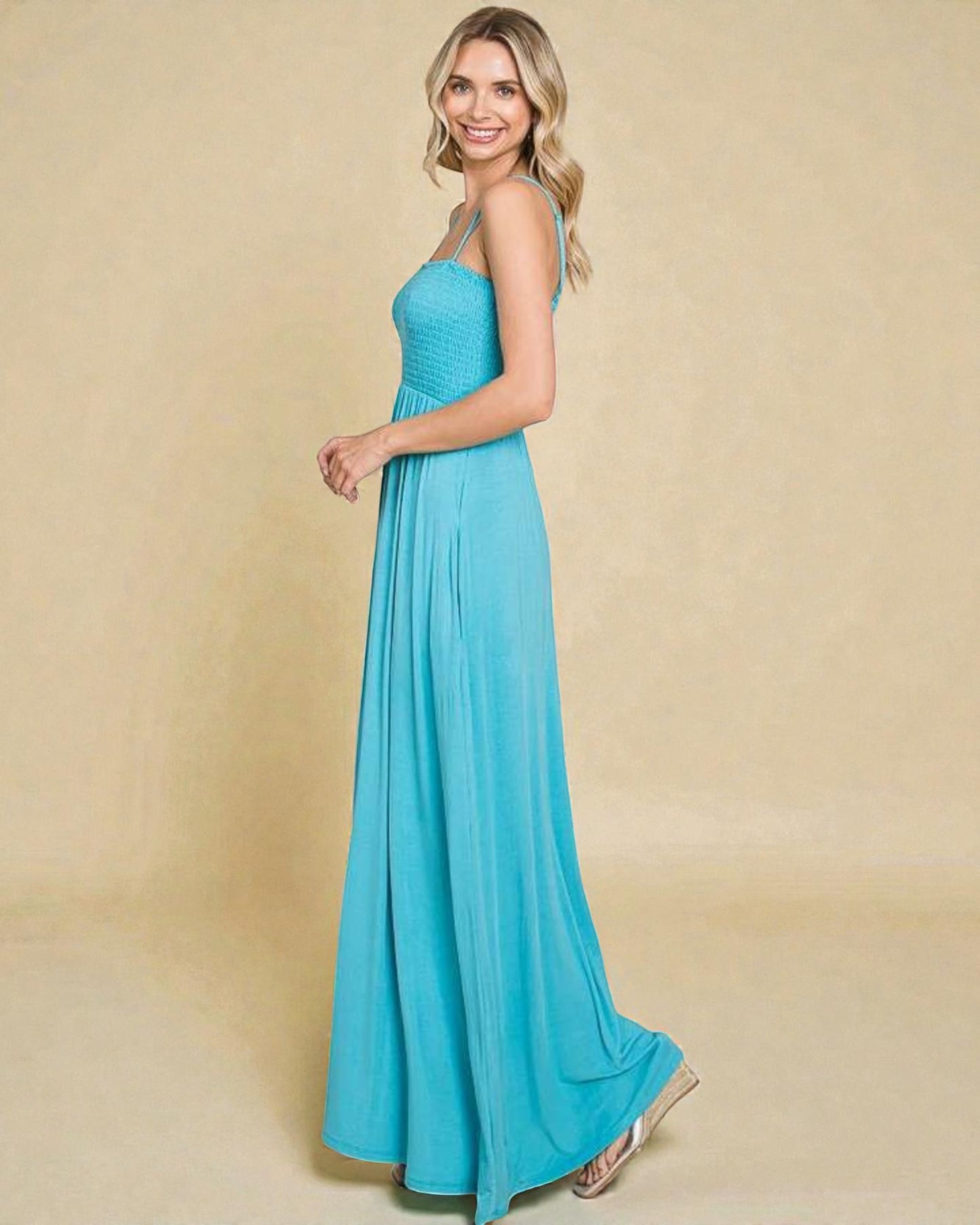 Woman wearing a blue dress against a beige background