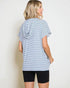 Woman wearing a blue and white striped t-shirt and black shorts on a plain background