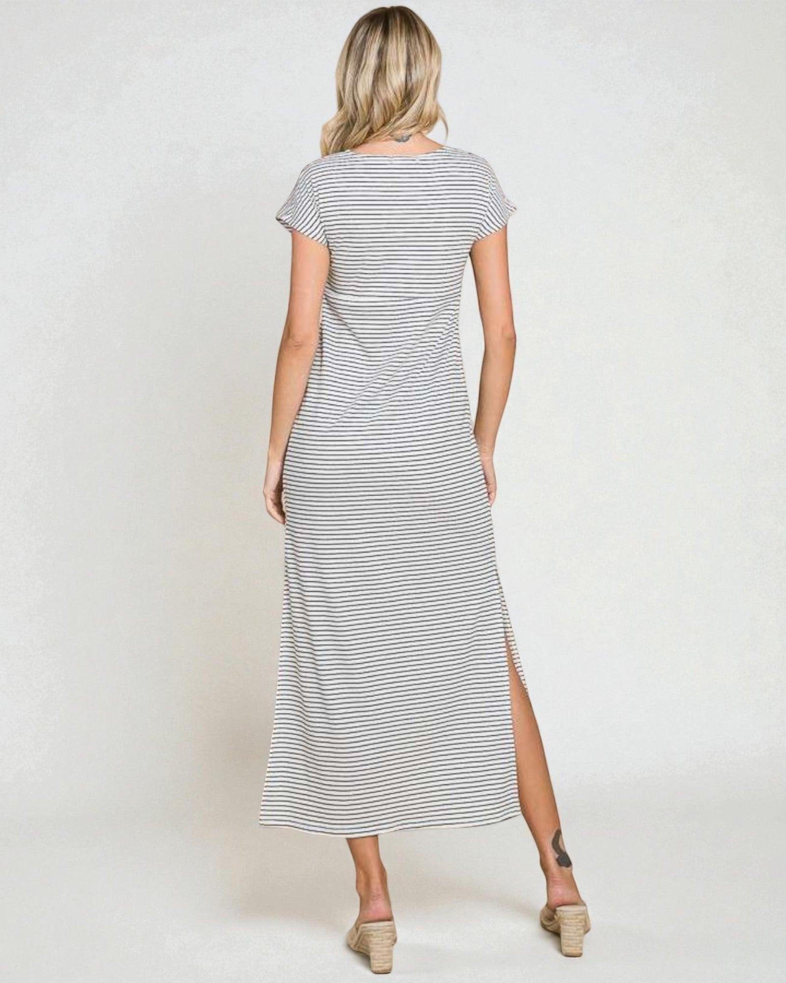 Woman wearing a striped dress with a white background