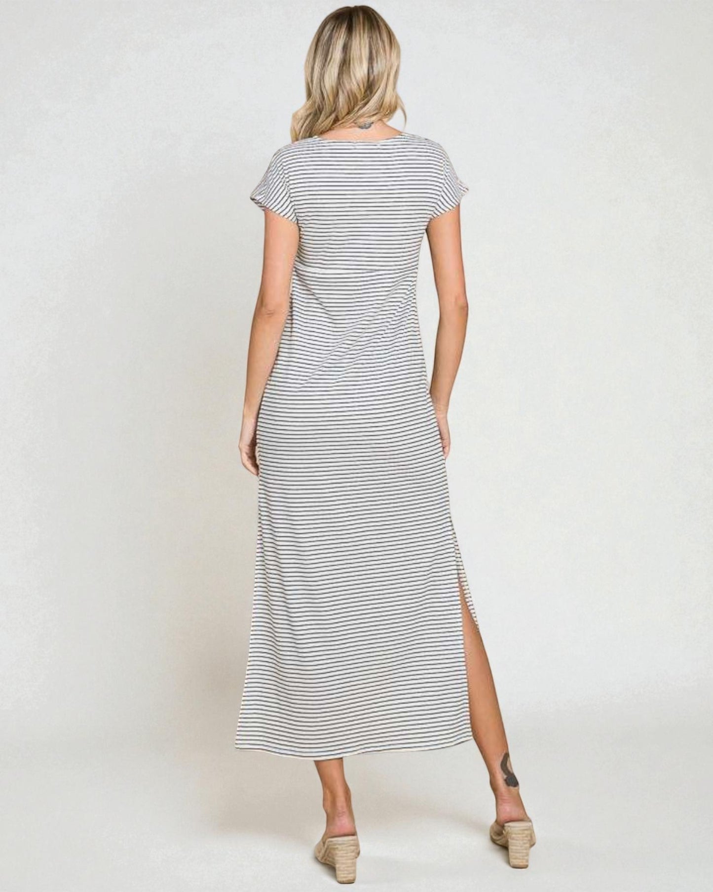 Woman wearing a striped dress with a white background