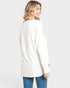 Woman wearing a white long-sleeve top on a plain background