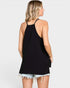 Woman wearing a black tank top and denim shorts on a white background