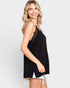 Woman wearing a black sleeveless top with lace details on a white background