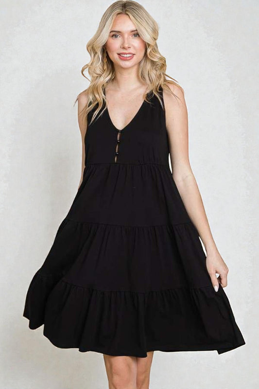 Woman wearing a black dress against a white background