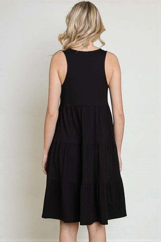 Black sleeveless dress worn by a person on a white background