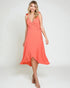 Woman wearing a coral dress on a white background