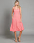 Woman wearing a pink dress against a gray background