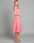 Woman wearing a pink dress against a gray background