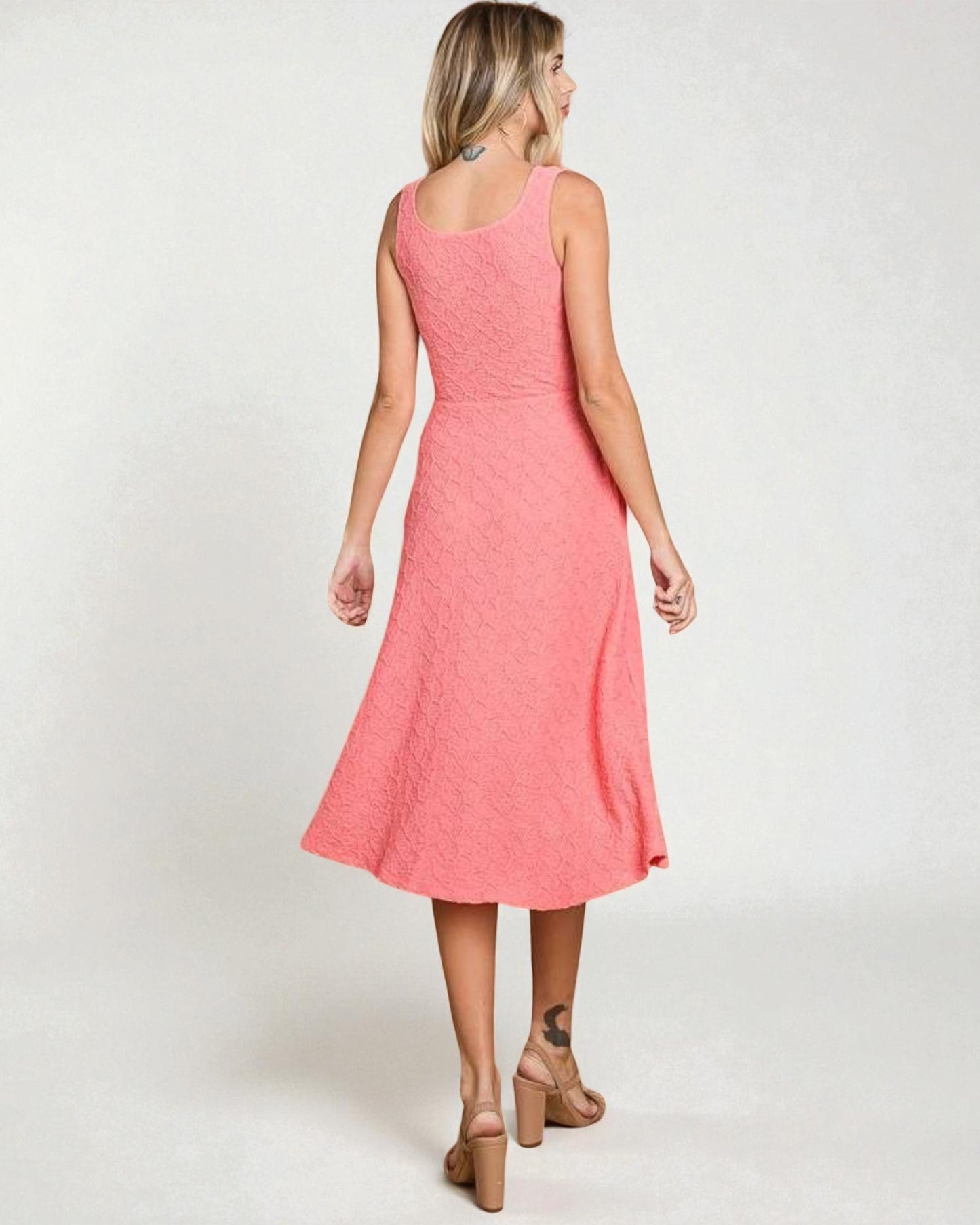 Woman wearing a pink dress on a white background