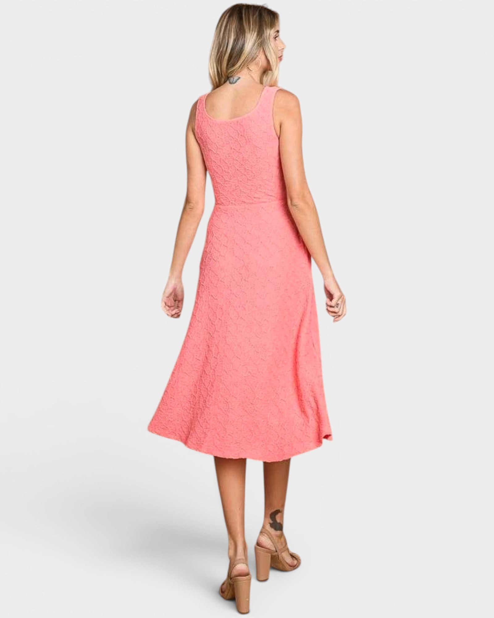 Woman wearing a pink dress on a white background